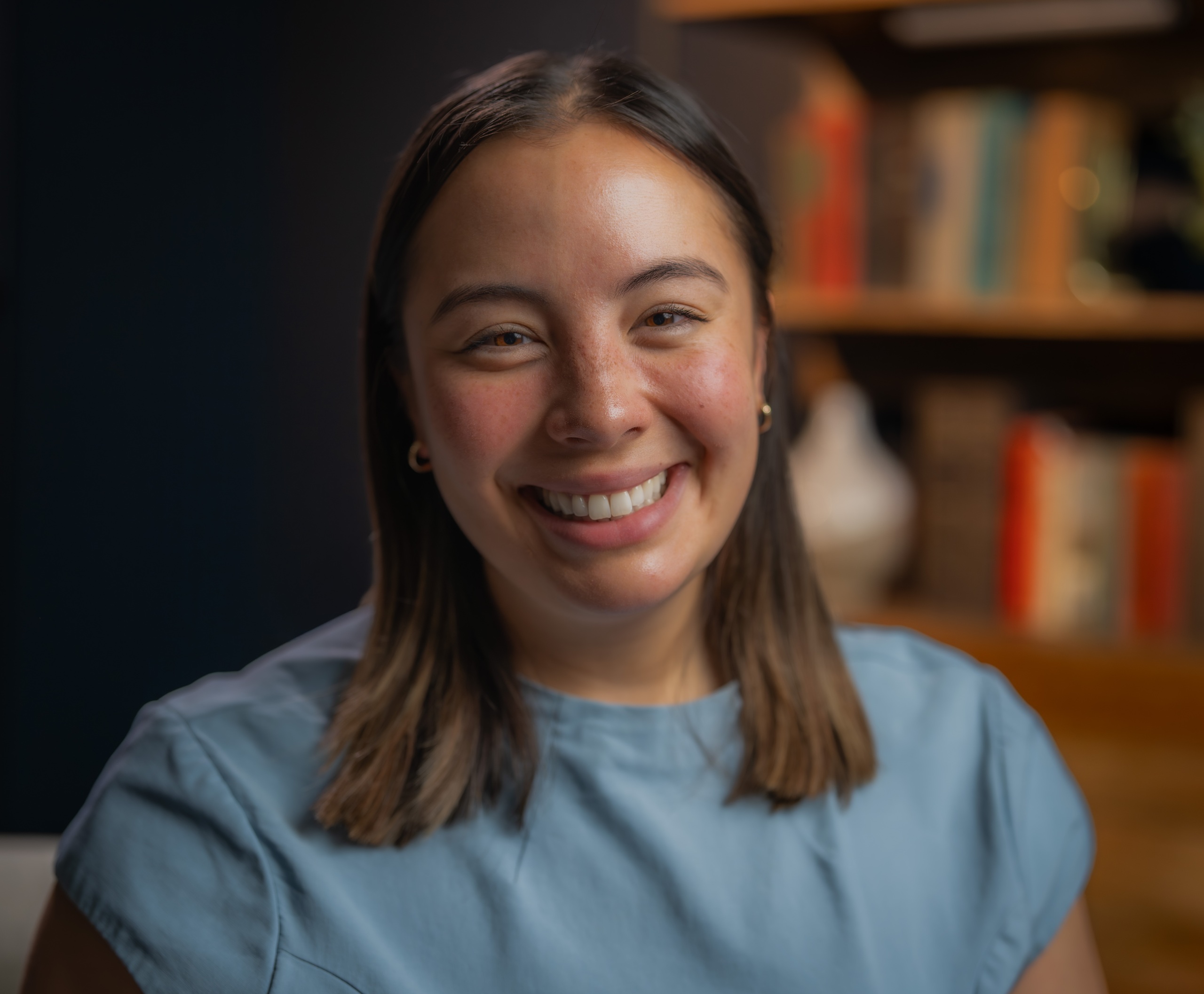 Headshot of Amanda Kwong wearing a blue dress and smiling.