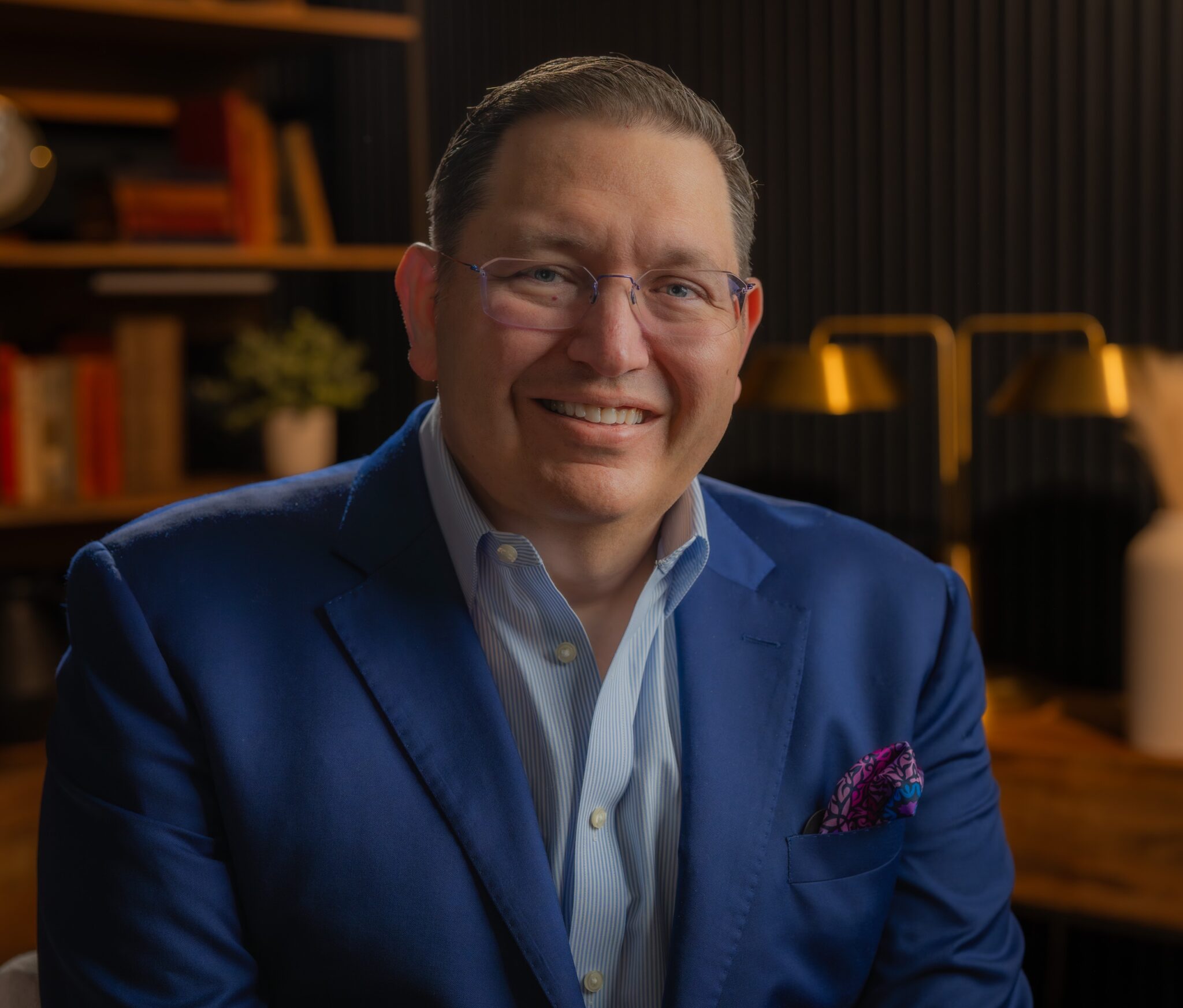 Headshot of Brian Castrucci wearing a blue suit and smiling.